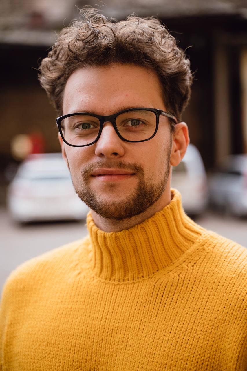 Portrait of Elvijs Ernests in a yellow turtleneck